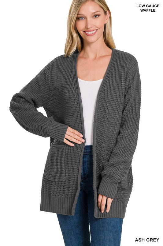 Ash grey soft and low gauge waffle sweater made from 100% Acrylic fabric. This relaxed fit sweater as shown on the model wearing it with a white shirt and blue jeans not sold on this website will give you the opportunity to relax, feel warm and look gorgeous while doing it! The perfect sweater for leggings and matching top or your favorite tee and jeans. Mid weight fabric makes this sweater great for pairing with any fit!