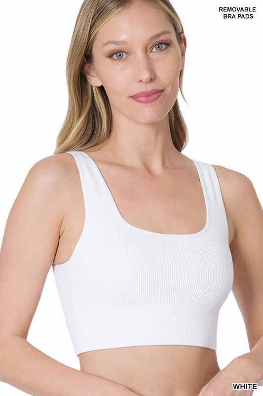 White ribbed square neck cropped tank top with removable bra pads. This tank top can easily be used for an exercise bra with firm yet flexible fabric. Real support and a comfortable yet supportive addition to your exercise or casual outfit. The smooth texture is made from nylon and spandex .