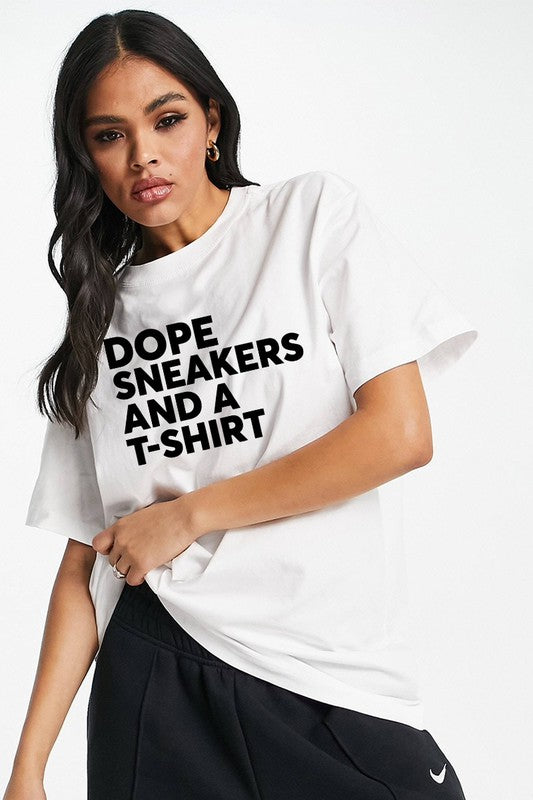 White 100% cotton tee shirt. Model showing top part of torso with product. Black lettering that says Dope Sneakers And A T-Shirt. Model also wearing black sweatpants that are not for sale.